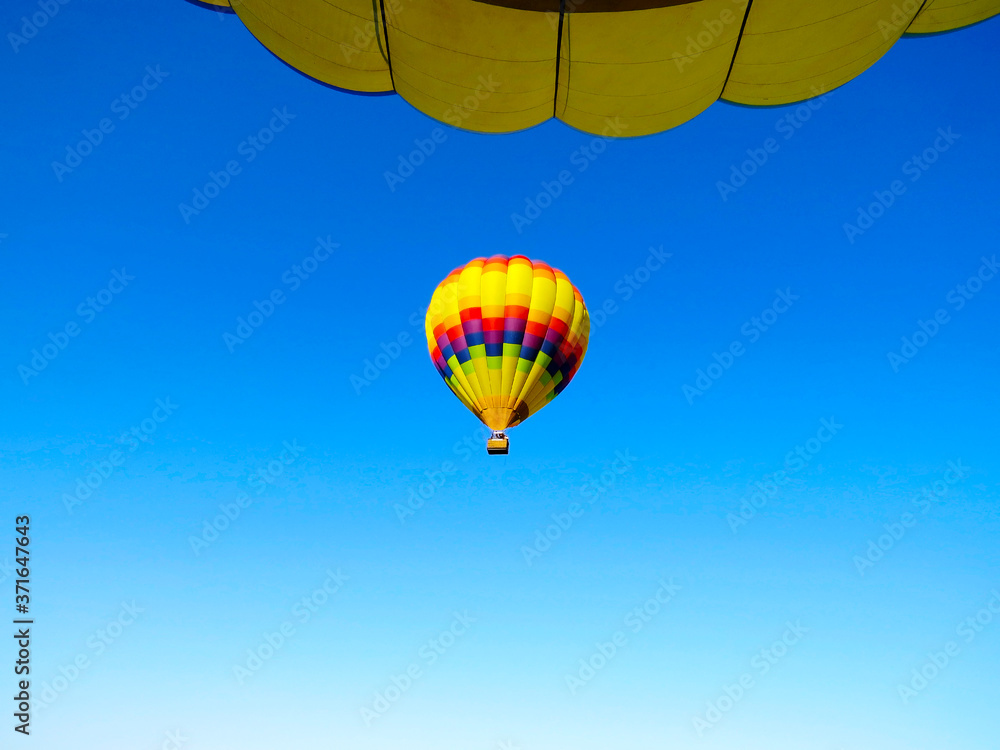 Fototapeta premium Beautiful colorful balloon flying in the blue sky