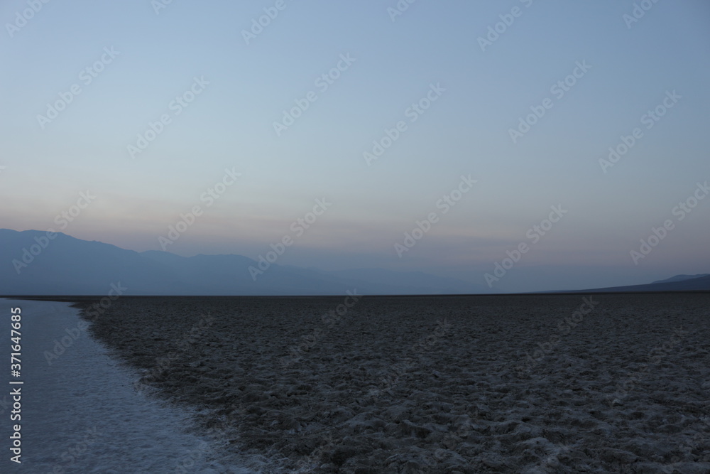 Badwater basin salt flats Death Valley at sunset in summer