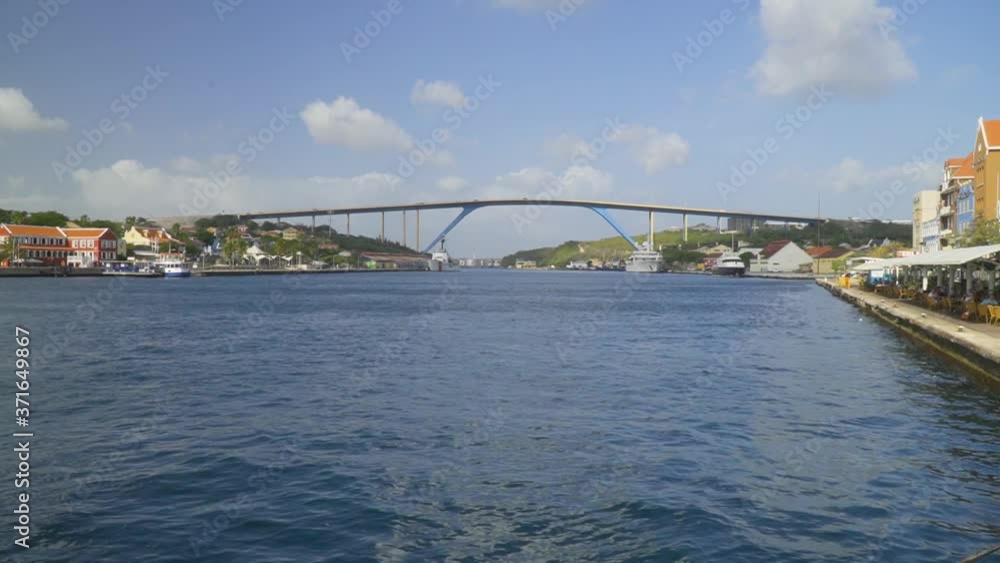 Transport bridge above river bay next to riverfront with street caf� and shops in Wllemstad Curacao Transport bridge above river bay next to riverfront with street caf� and shops in Wllemstad Curacao