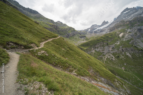 landscape near Oberbärgli, near the oeschinensee in switzerland. Hiking trails lead past the hut, which is a restaurant for hikers. the goods are transported to the hut by helicopter.

 photo