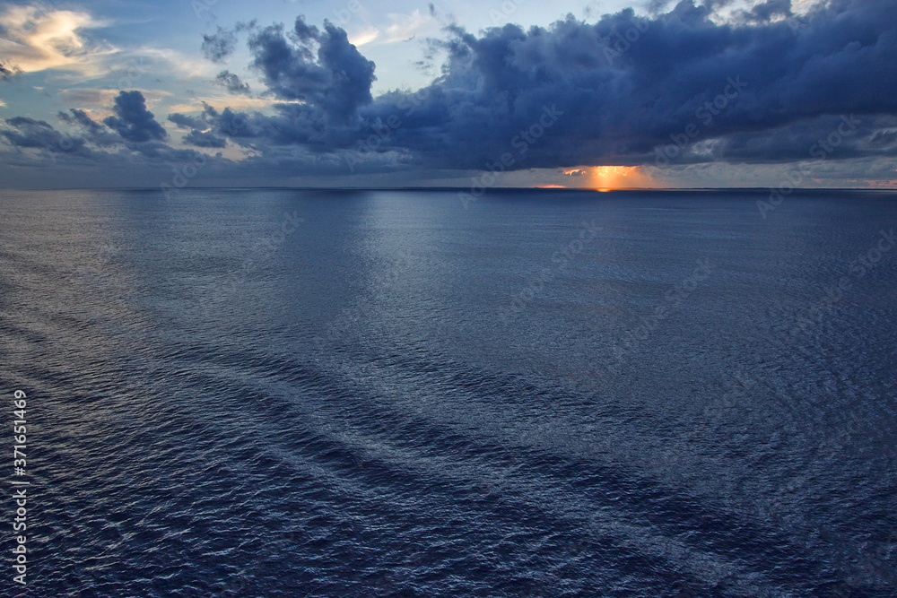 Colorful Sunset with Calm Waves While At Sea on a Ship