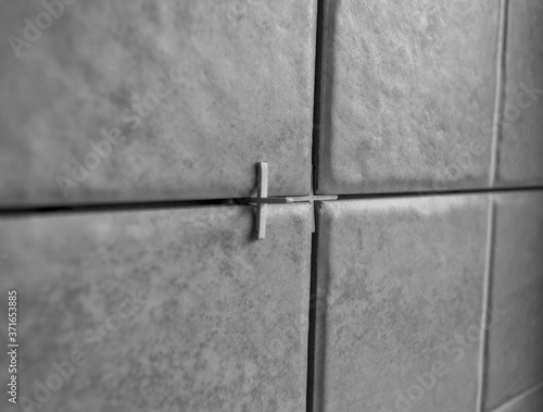repair of tile wall tiles, plastic crosses and fixtures for leveling tiles. black and white 
