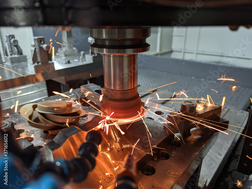 cnc milling of hardened steel with sparks - closeup with selective focus and blur