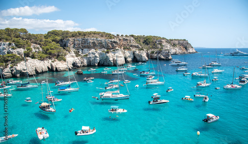 Menorca, Spain, Balearic Islands, Cala Macarella beach, anchored boats by cliffs