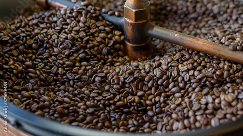 Coffee beans is roasting in roaster machine in coffee shop.