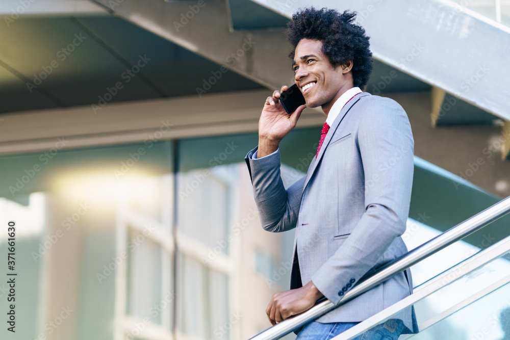 Black Businessman using a smartphone near an office building Black Businessman using a smartphone near an office building