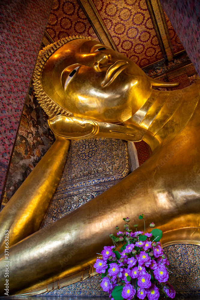 Golden reclining Buddha in the Temple of Wat Pho, in Bangkok, Thailand.
