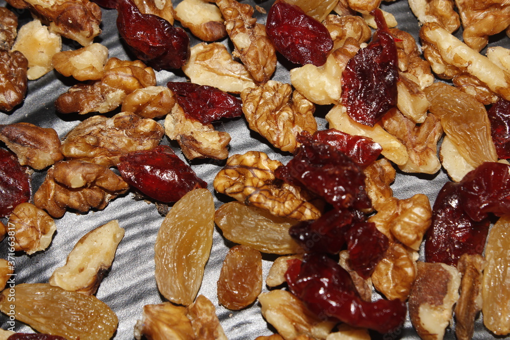 mixed dry fruits raisins walnuts cranberries in black background mixed dry fruits raisins walnuts cranberries in black background
