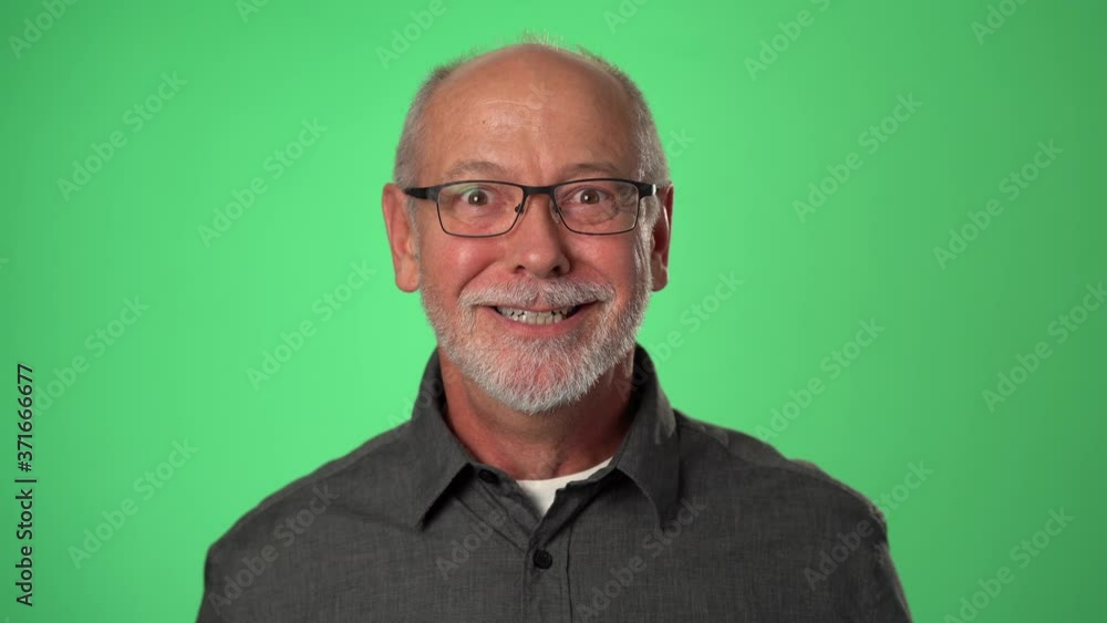 Man shocked, saying WOW. Handsome guy with bald gray hair surprised to camera on green screen background. Man shocked, saying WOW. Handsome guy with bald gray hair surprised to camera on green screen background.