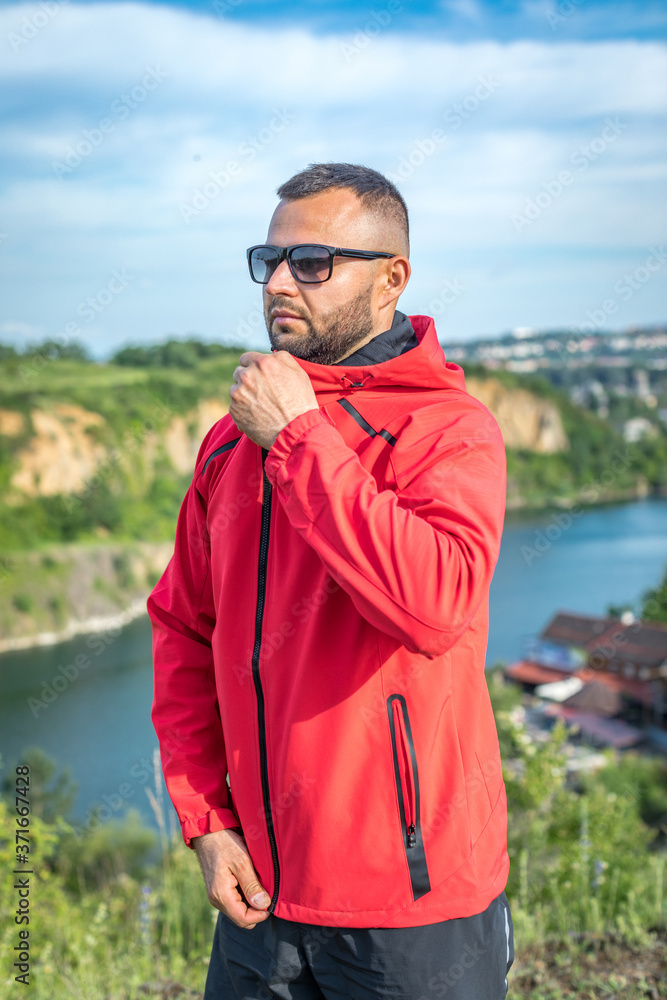 Young attractive bearded man at quarry lake, enjoying the view. Camping trip at weekend concept. Young attractive bearded man at quarry lake, enjoying the view. Camping trip at weekend concept.