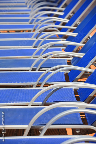 Blue pool chairs arranged in a row 