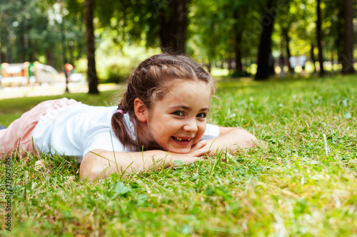 little cute caucasian girl playing cheerful in green park at summer, lifestyle people concept