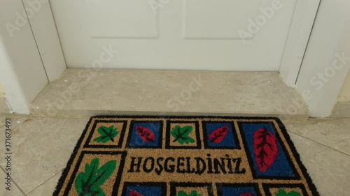 Fethiye, Turkey - 10th of August 2020: 4K Tilt a doormat saying Welcome in Turkish 
 photo