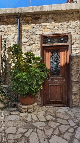 old wooden door.  Combination of wood with stone.  Wooden door in a stone house