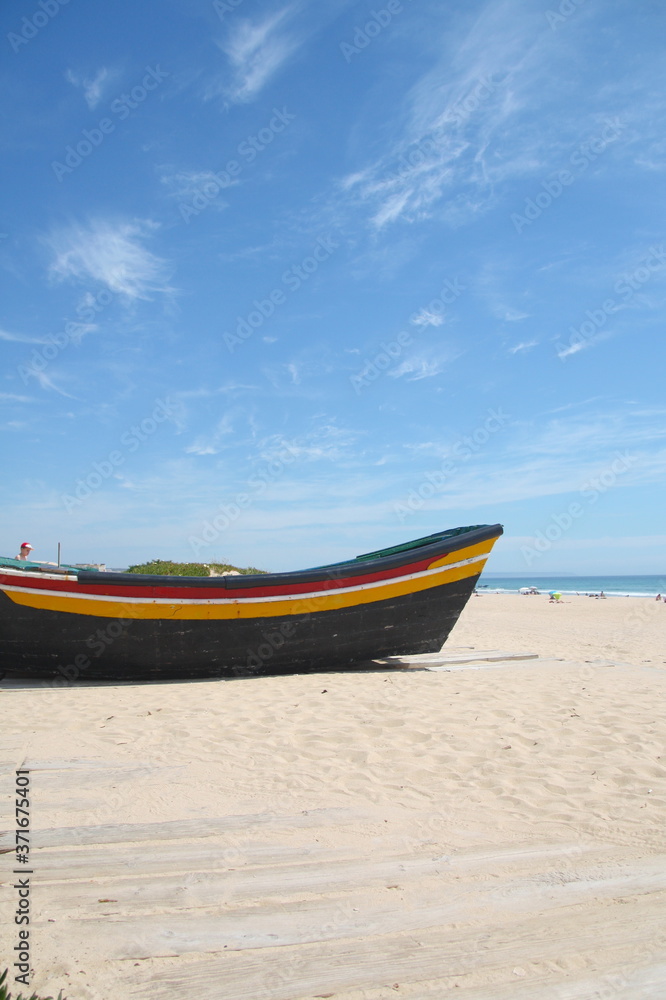 Typical fishing boat on the Costa da Caparica Beach, near Lisbon, Portugal.