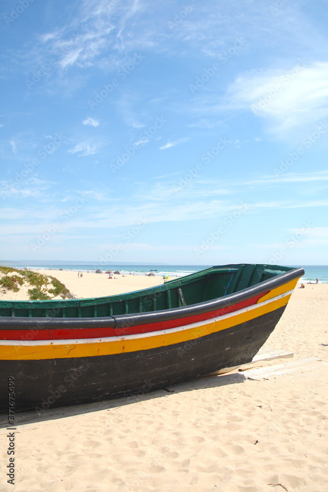 Naklejka premium Typical fishing boat on the Costa da Caparica Beach, near Lisbon, Portugal.