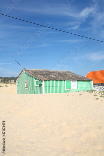 Typical tiny wooden colorful house, in Costa da Caparica, Lisbon, Portugal.