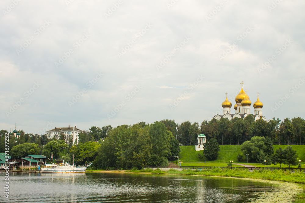 panoramic view of the Golden domes of the assumption Cathedral and the green foliage of trees on a bright summer day and space for copying in Yaroslavl Russia