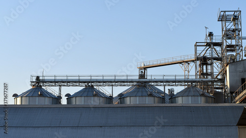 Complex of agriculturtal elevators for grain storage at sunset. 