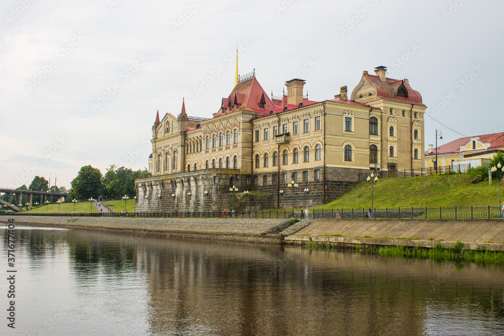 historical Museum on the Bank of the Volga river and reflection on a cloudy summer day and space for copying in Rybinsk Russia