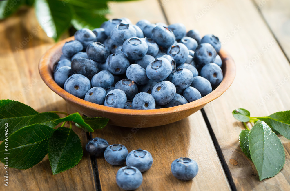 Blueberries in a plate and pancakes, on an old background. Blueberries in a plate and pancakes, on an old background.