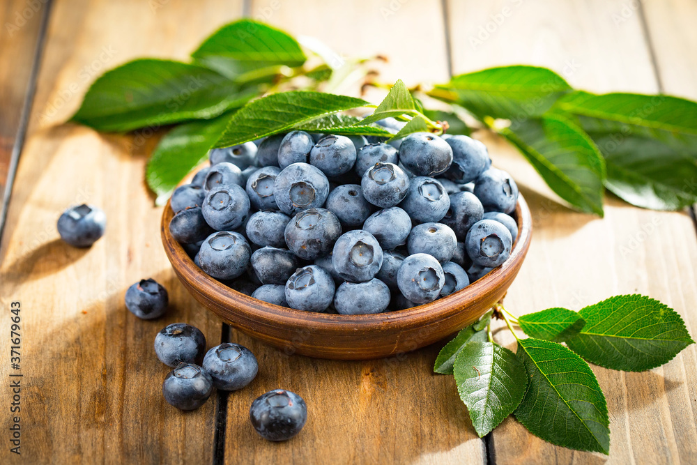 Blueberries in a plate and pancakes, on an old background. Blueberries in a plate and pancakes, on an old background.