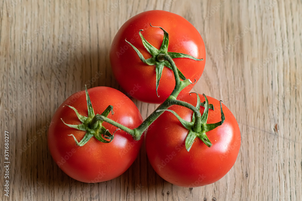 fresh tomatoes on a wooden table fresh tomatoes on a wooden table