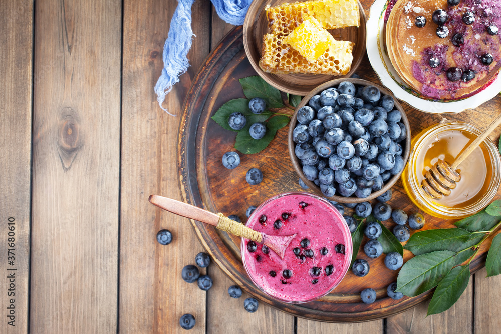 Ripe, fresh blueberries in a wooden bowl on an old background. Ripe, fresh blueberries in a wooden bowl on an old background.