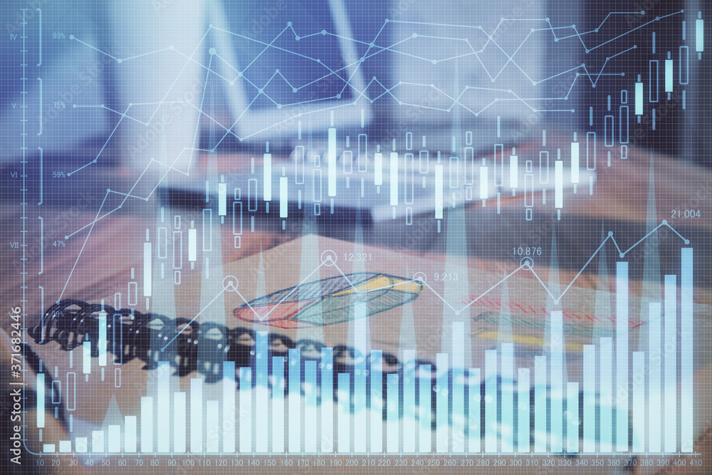 Double exposure of financial graph drawings and desk with open notebook background. Concept of forex market Double exposure of financial graph drawings and desk with open notebook background. Concept of forex market