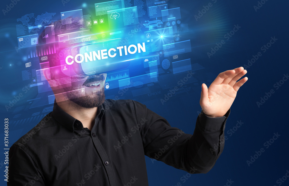 Businessman looking through Virtual Reality glasses with CONNECTION inscription, innovative security concept Businessman looking through Virtual Reality glasses with CONNECTION inscription, innovative security concept
