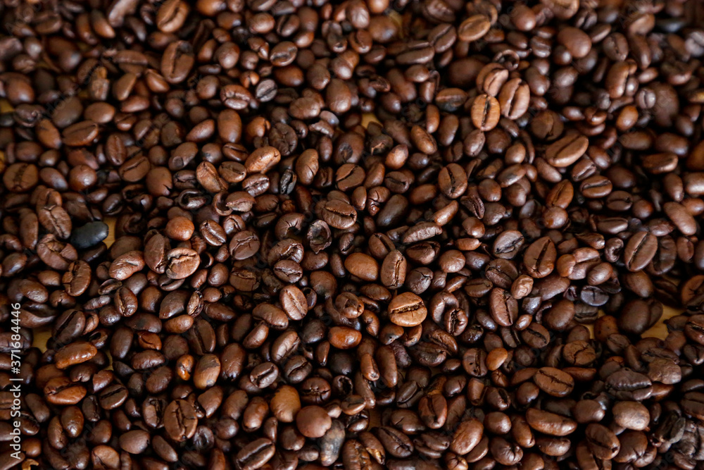 Coffee grains on wooden table, with natural light Coffee grains on wooden table, with natural light