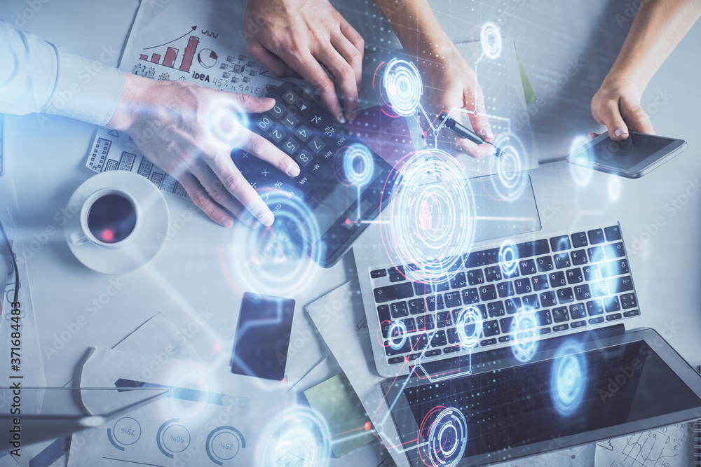 Double exposure of man and woman working together and data theme hologram drawing. Computer background. Top View. Double exposure of man and woman working together and data theme hologram drawing. Computer background. Top View.