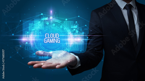 Man hand holding CLOUD GAMING inscription, technology concept