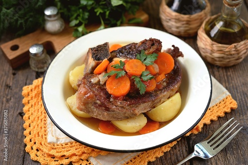Braised beef with onions and carrots with boiled potatoes.