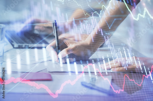 Multi exposure of woman hands typing on computer and financial chart hologram drawing. Stock market analysis concept.