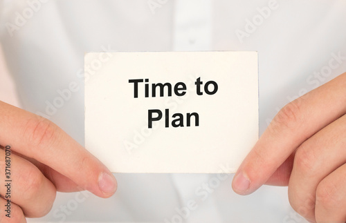 Man's hands take a card with words Time to plan, finance and business concept.