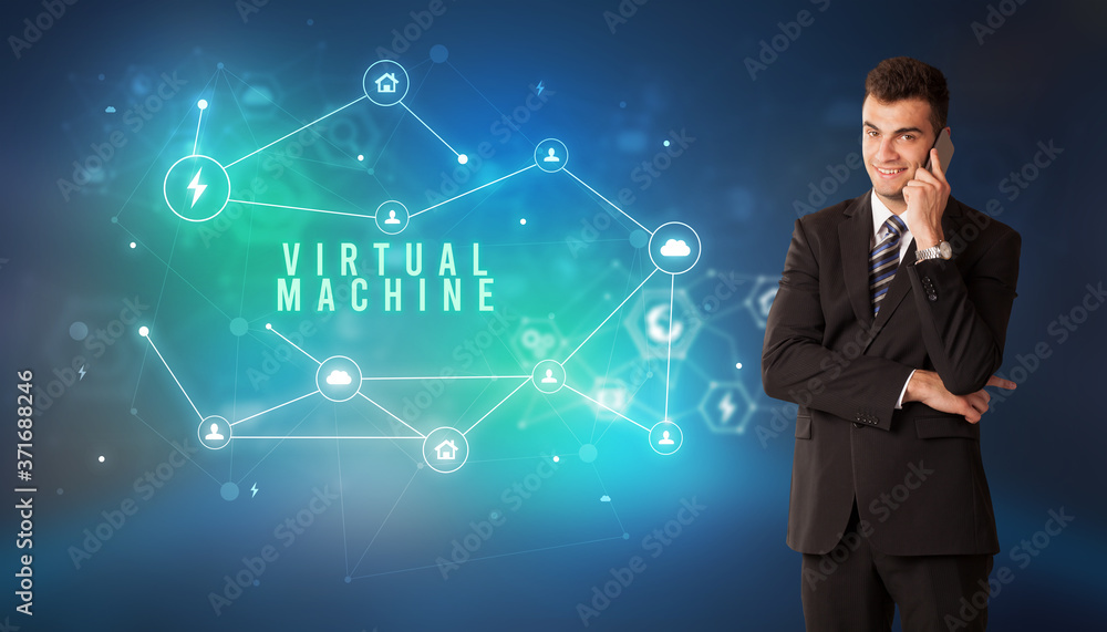 Businessman in front of cloud service icons with VIRTUAL MACHINE inscription, modern technology concept Businessman in front of cloud service icons with VIRTUAL MACHINE inscription, modern technology concept