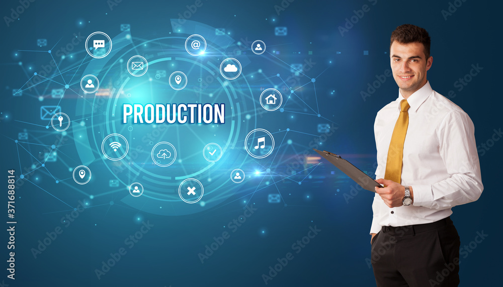 Businessman thinking in front of technology related icons and PRODUCTION inscription, modern technology concept Businessman thinking in front of technology related icons and PRODUCTION inscription, modern technology concept