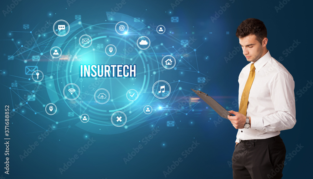 Businessman thinking in front of technology related icons and INSURTECH inscription, modern technology concept Businessman thinking in front of technology related icons and INSURTECH inscription, modern technology concept