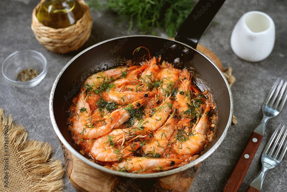 Fried shrimps in tomato sauce with garlic, dill and lemon juice. Healthly food.