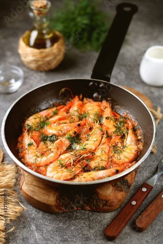Fried shrimps in tomato sauce with garlic, dill and lemon juice. Healthly food.