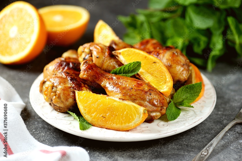 Chicken drumsticks baked with orange and mint. Organic food. Chicken drumsticks baked with orange and mint. Organic food.