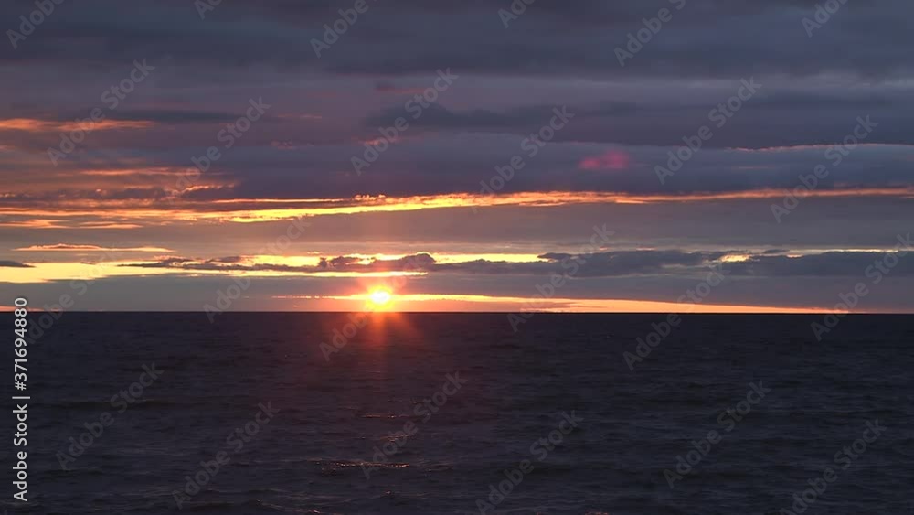 Wide dark beautiful bright sunset streaks golden in sky, shimmer bright lines, Lake Huron static Wide dark beautiful bright sunset streaks golden in sky, shimmer bright lines, Lake Huron static