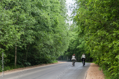 People riding bicycles in summer park