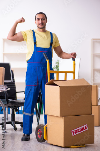 Young male contractor in moving concept