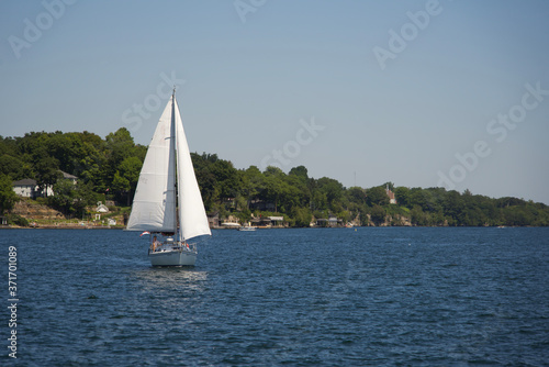 A sail boat on a river on a sunny, summers day