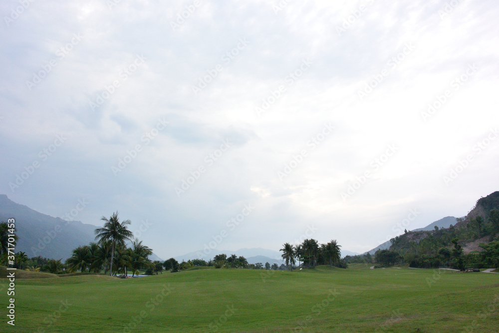 View of the golf course on the background of the mountains