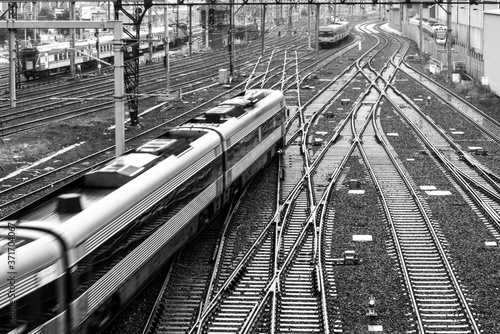 Train Moving Along Tracks in City