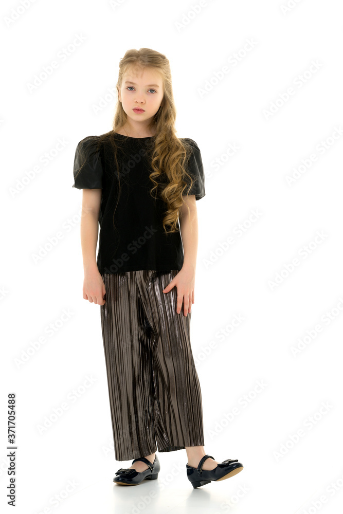 Cute little girl in a pantsuit. Isolated on a white background. Cute little girl in a pantsuit. Isolated on a white background.
