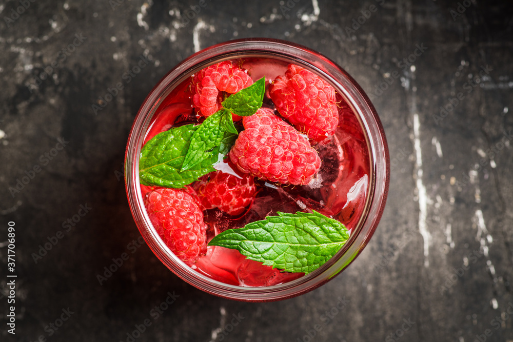 Raspberry and mint cocktail in glass on the rustic background. Selective focus. Shallow depth of field. Raspberry and mint cocktail in glass on the rustic background. Selective focus. Shallow depth of field.